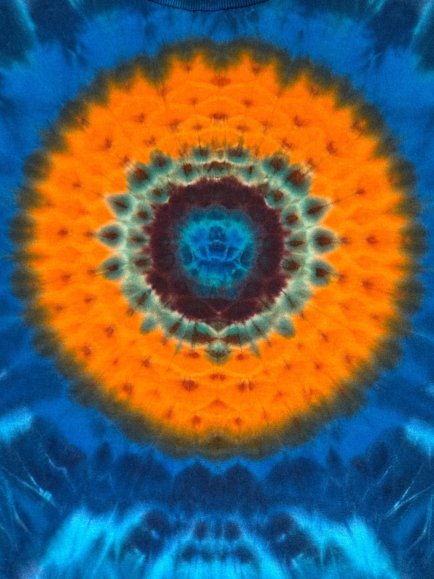 L - orange mandala on a sea of blues tee